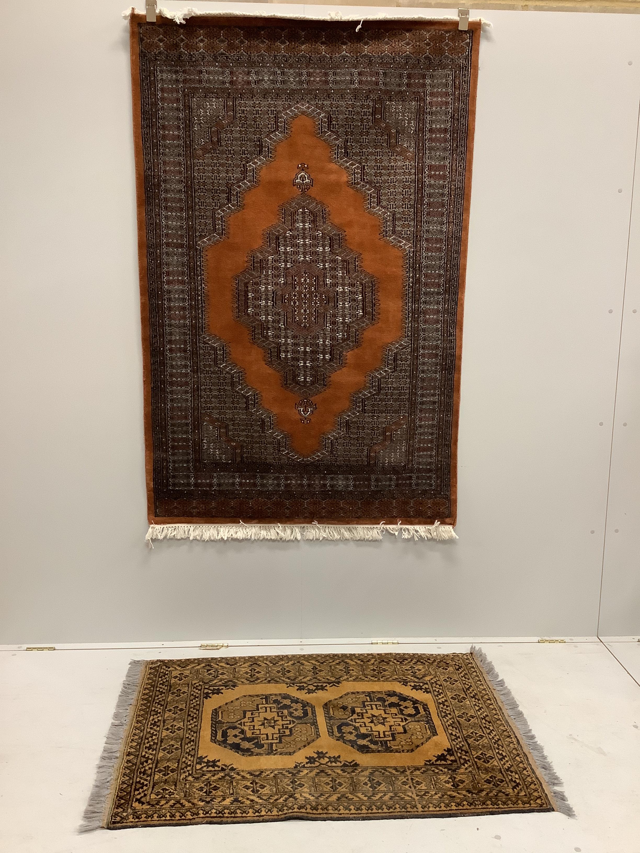 A Bokhara red ground rug and an Afghan rug, larger 184 x 120cm